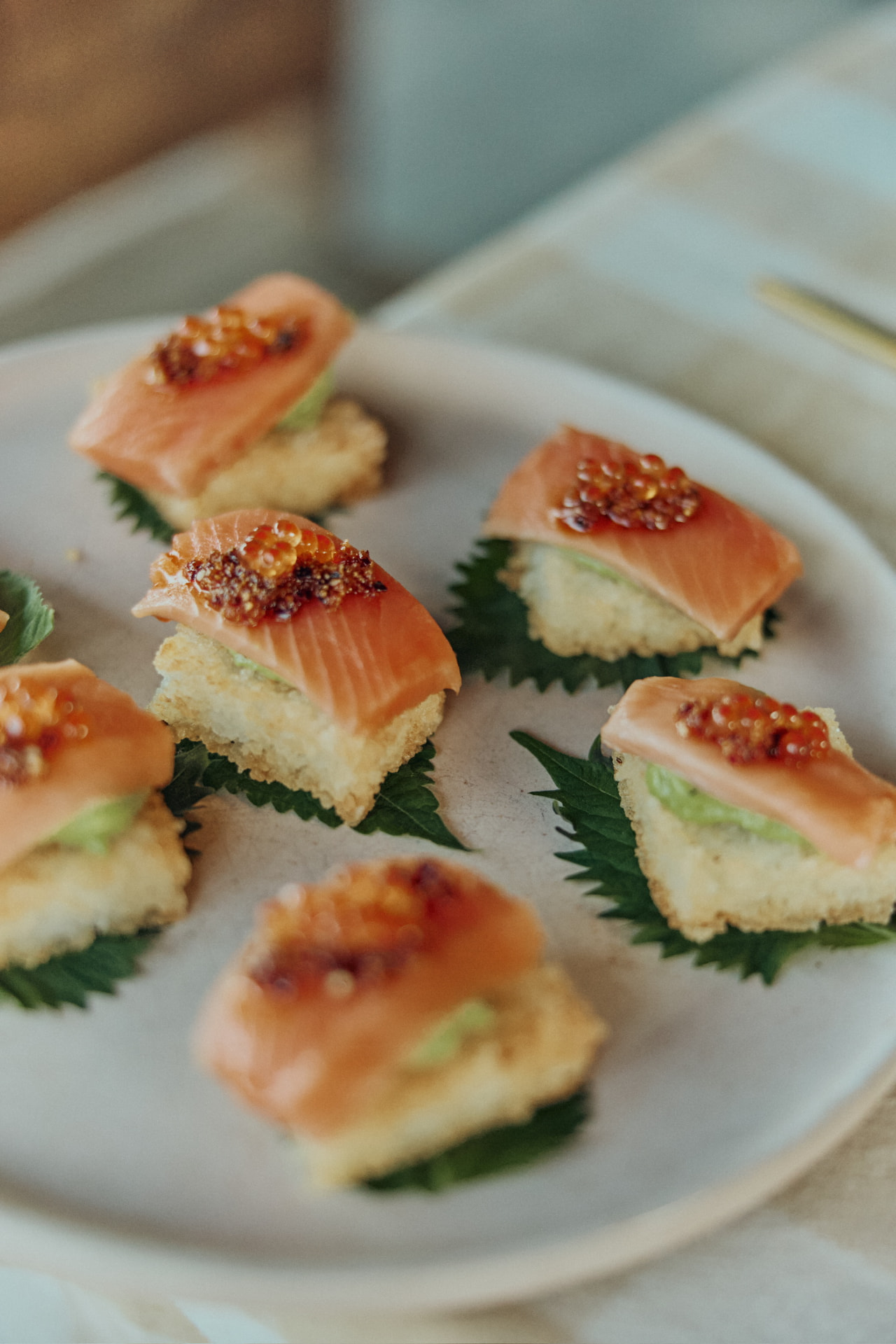 Cured salmon canapés with trout roe on shiso leaves